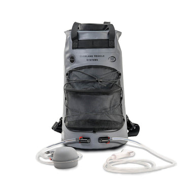 Image of Overland Vehicle Systems portable camp shower bag with front mesh pocket, dual hose connections, clear tubing and shower head, gray waterproof roll-top design shown front view on white background