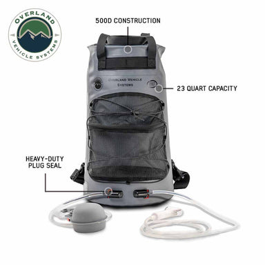 Image of Overland Vehicle Systems portable camp shower bag highlighting 500D construction, 23-quart capacity and heavy-duty plug seal, gray roll-top design with mesh pocket, hoses and shower head shown front view on white background