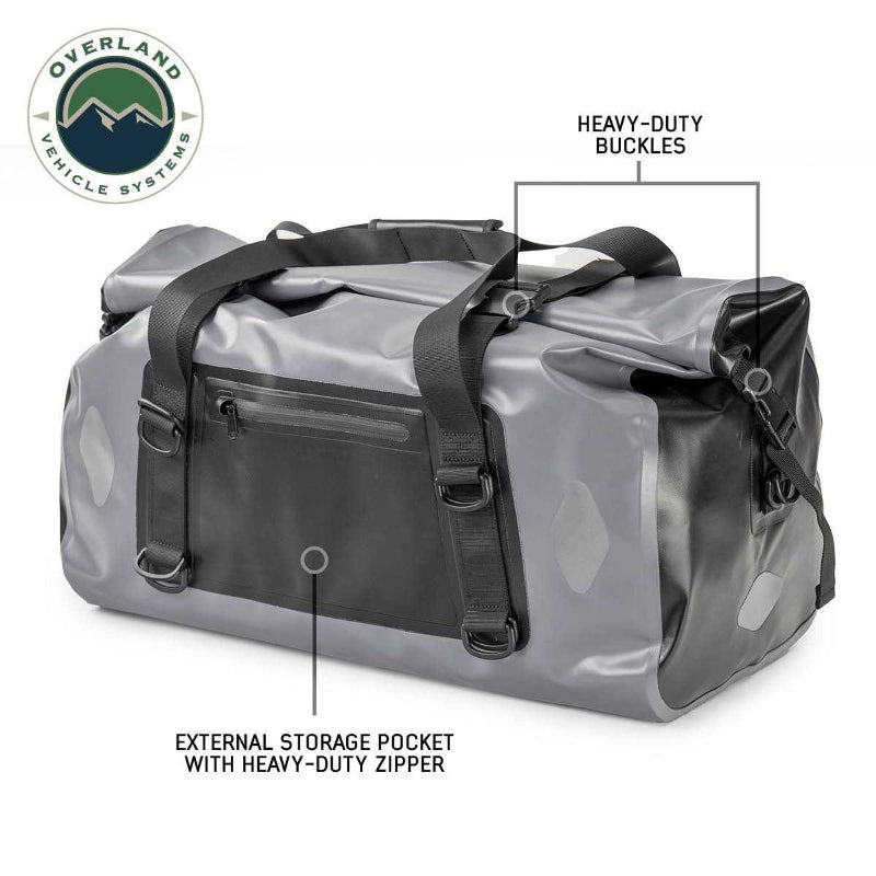 Image of a gray and black Overland Vehicle Systems IPX6 waterproof duffel bag, highlighting its heavy-duty buckles and external storage pocket with a heavy-duty zipper.
