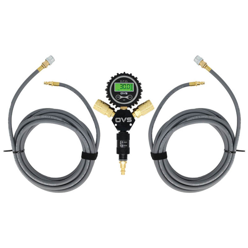 An image of an Overland Vehicle Systems (OVS) D.T.D. digital tire deflator kit. The kit features a central black manifold with a green digital pressure gauge displaying "30.0 PSI," connected to two coiled gray air hoses with brass fittings and universal quick connect chucks. The setup is presented against a clean white background