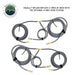 An image displaying two sets of gray air hoses for the Overland Vehicle Systems (OVS) 4-way tire inflation/deflation system. Each set consists of a main hose branching into two shorter hoses, all equipped with brass fittings and quick connect chucks, neatly coiled and secured with straps. The text at the top states "EQUALLY INFLATE/DEFLATE 4 TIRES AT ONCE WITH THE OPTIONAL 4-WAY HOSE SYSTEM."