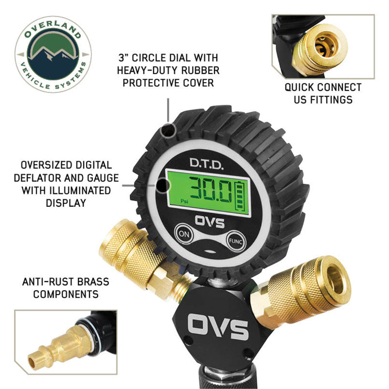 An image showcasing a close-up of the Overland Vehicle Systems (OVS) D.T.D. digital tire deflator gauge. The central feature is a black 3-inch circular dial with a heavy-duty rubber protective cover, displaying a green illuminated digital reading of "30.0 PSI." Below the gauge, anti-rust brass quick connect US fittings are visible. Insets highlight "QUICK CONNECT US FITTINGS" and "ANTI-RUST BRASS COMPONENTS." The text describes it as an "OVERSIZED DIGITAL DEFLATOR AND GAUGE WITH ILLUMINATED DISPLAY."