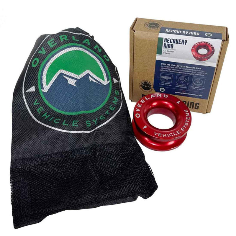 Image of Overland Vehicle Systems recovery ring with red anodized aluminum ring, branded black mesh storage bag, and retail box packaging, front angled view on white background.