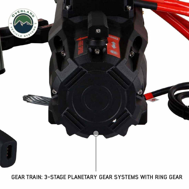 Image of the OVS SCAR 12 Steel Cable Winch motor housing, with a close-up, bottom-up view on a white background. The text "GEAR TRAIN: 3-STAGE PLANETARY GEAR SYSTEMS WITH RING GEAR" is visible below the image