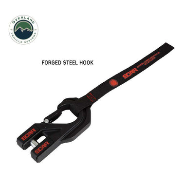 Image of a black OVS SCAR forged steel winch hook with a red-accented strap, featuring the 'SCAR' and 'Overland Vehicle Systems' logos. Angled view on a white background