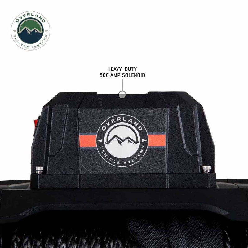 Image of a close-up on the heavy-duty 500 amp solenoid of the Overland Vehicle Systems (OVS) SCAR winch, showing the brand's logo. A text label points to the solenoid, emphasizing its heavy-duty rating