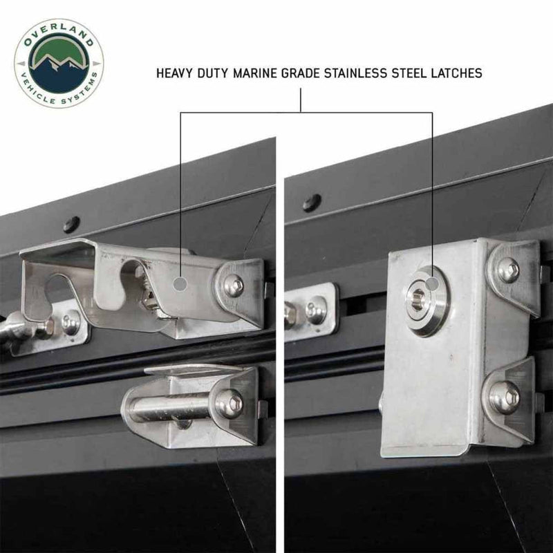 Image displaying a close-up of two heavy-duty marine-grade stainless steel latches on a black hardshell rooftop tent, with one latch open and the other closed, highlighting their robust construction. The "Overland Vehicle Systems" logo is in the top left corner, all on a white background