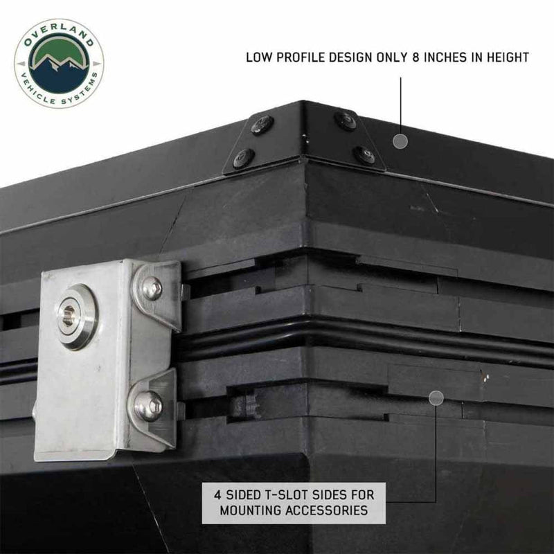 Image showing a close-up of a black hardshell rooftop tent, highlighting its low-profile design of only 8 inches in height and 4-sided T-slot sides for mounting accessories, with a metal clasp visible. The "Overland Vehicle Systems" logo is in the top left corner, all on a white background