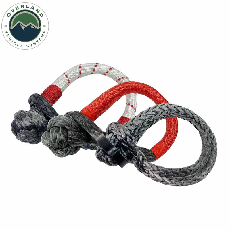 Image of Overland Vehicle Systems soft shackles in multiple sizes with gray braided synthetic rope, black steel collars, and red protective sleeves, grouped together in angled front view on white background.