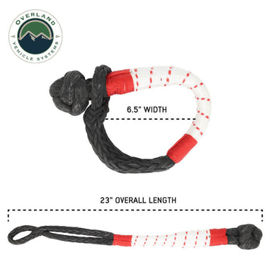 Image showing two views of a black soft shackle with red and white striped protective sleeving: one looped view with a 6.5" width label, and one extended view with a 23" overall length label, on a white background with the "Overland Vehicle Systems" logo.