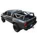 Image of Overland Vehicle Systems mid-height rack mounted on a black pickup truck, side view showing the sturdy metal frame and open truck bed, on a white background