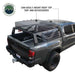 Image of Overland Vehicle Systems mid-height rack mounted on a black pickup truck, showing the rack's capability to easily mount a roof top tent and accessories, with a clear view of the truck bed and rugged outdoor background