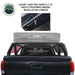Image of a Sherpa rooftop tent mounted on a pickup truck's mid-height rack, with a close-up view showing the easy installation mechanism, highlighting the crossbars and mounting bolt for secure tent attachment, set against a clear background