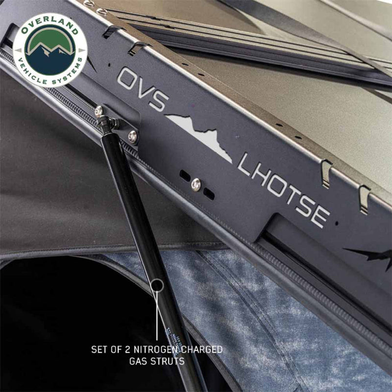 Image of Overland Vehicle Systems Lhotse rooftop tent with a set of two nitrogen charged gas struts, close-up view of the hardware and tent structure on a white background