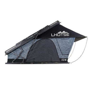 Image of Overland Vehicle Systems Lhotse rooftop tent with black and blue fabric, angled side view showing the XD Series branding, mounted on a vehicle with deployed support poles