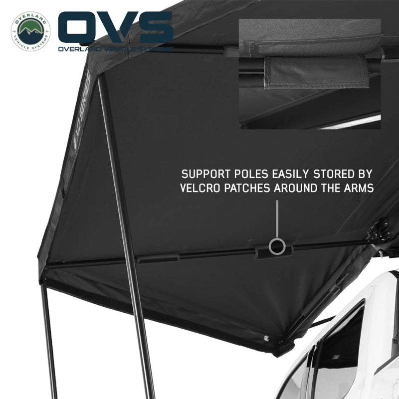 Image of the underside of a deployed black awning, highlighting how support poles are easily stored by velcro patches around the arms, with an inset showing a close-up of a velcro patch.
