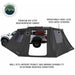 Image of OVS XD Nomadic 180 LTE awning walls installed around a pickup truck, black ripstop fabric with mesh window panels and feature callouts, shown in side view on a white background.