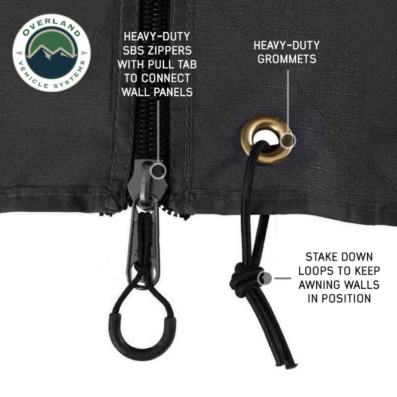 Image of OVS XD Nomadic 180 LTE awning wall hardware close-up showing heavy-duty zipper, reinforced grommet, and stake-down loop on black fabric against a white background.