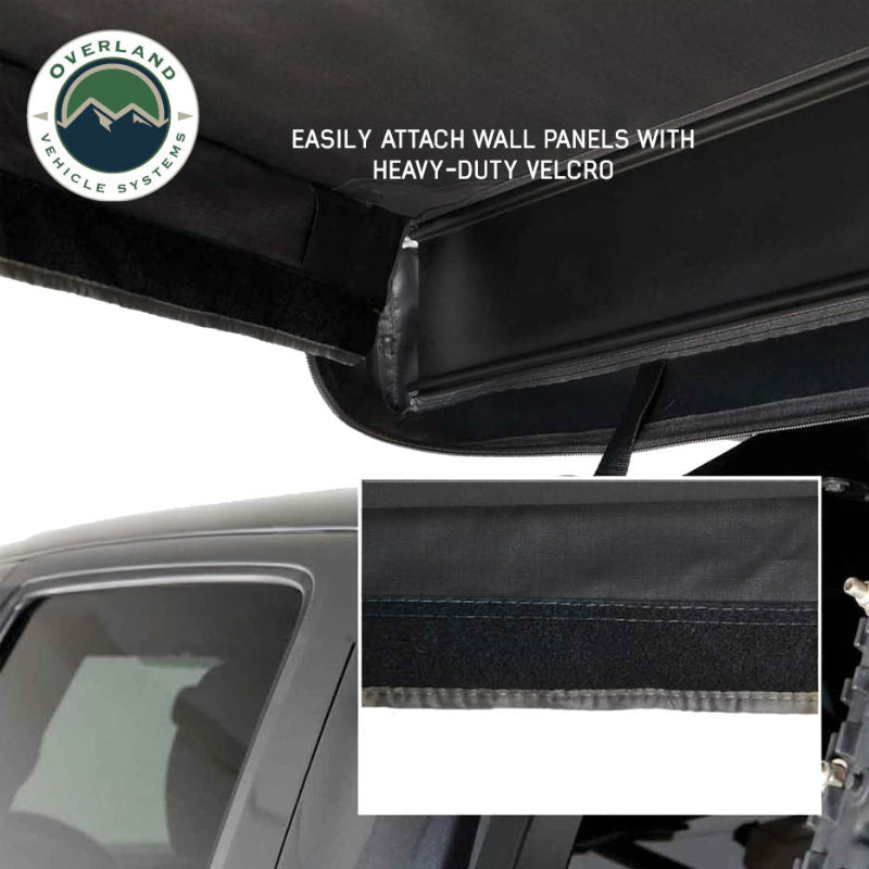 Image of OVS XD Nomadic 180 LTE awning wall attachment detail showing heavy-duty Velcro securing black fabric panel to awning frame, close-up angled view on a white background.