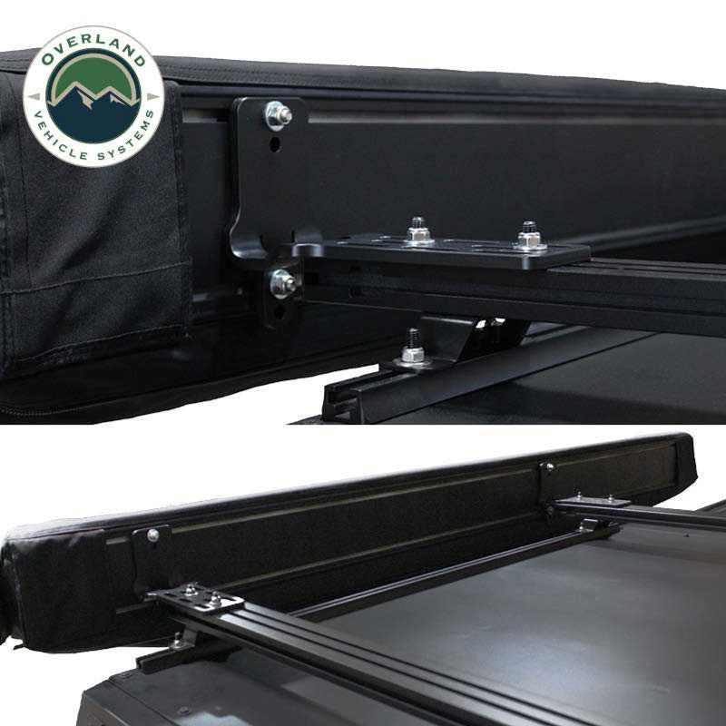 Image providing a close-up view from underneath a black Overland Vehicle Systems awning, highlighting the 5000 PU black out undercoating of the fabric. The "Overland Vehicle Systems" logo is in the top left corner