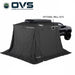 Image of an OVS XD Nomadic 270 LTE awning fully enclosed with optional wall kits attached, black fabric forming a complete sheltered room around a pickup truck, shown in angled rear and side view on a white background.