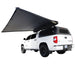 Image of OVS Nomadic 180 Awning partially deployed with LED lights, black fabric, angled rear and side view on white Toyota Tundra pickup truck on white background