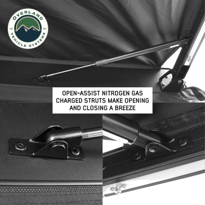 Image of the Nomadic Awning showing a close-up of the open-assist nitrogen gas charged struts, highlighting their function in making opening and closing easier. The awning has black fabric