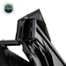 Close-up, angled view of the OVS Nomadic Awning, showing the internal hardware and LED wiring. The black awning fabric is partially open, revealing the black support arms and the integrated LED lighting system's cables