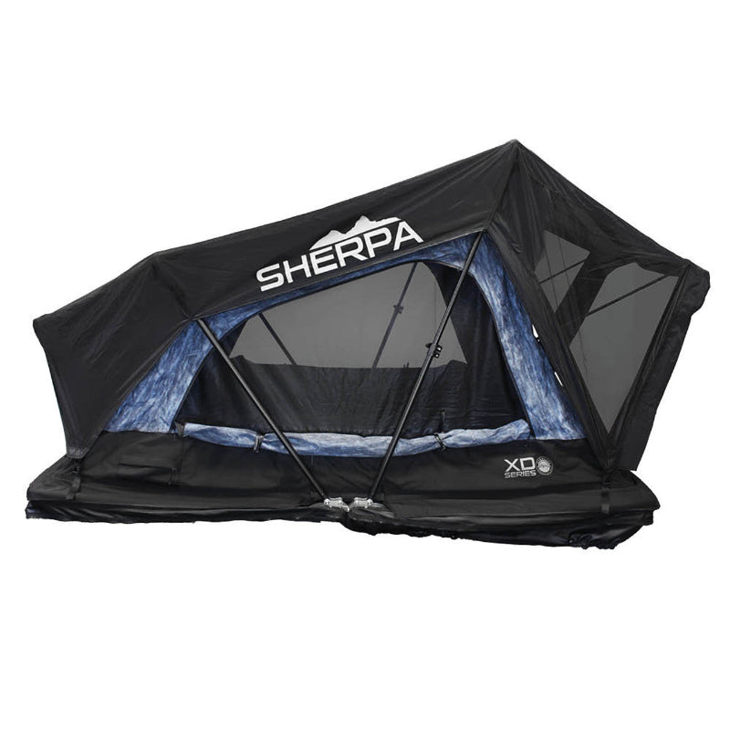 Image of an Overland Vehicle Systems XD Series Sherpa Roof Top Tent, fully deployed with a black exterior and a light blue patterned interior visible through the mesh windows, shown at an angle on a white background. The "SHERPA" logo is prominently displayed on the front of the tent