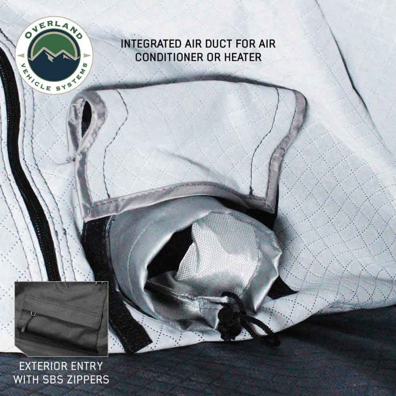 Image close-up of a rooftop tent's interior, highlighting an integrated air duct designed for an air conditioner or heater, along with a detail of an exterior entry with SBS zippers. The "Overland Vehicle Systems" logo is in the top left corner
