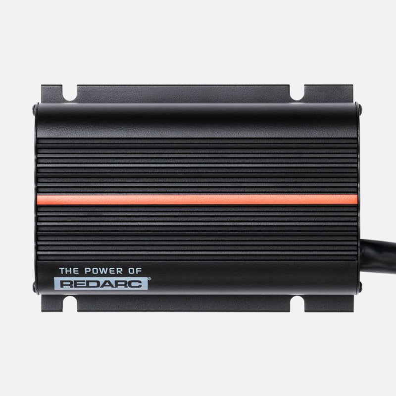 Image of the top of a REDARC BCDC Classic 50A Battery Charger with a red stripe running across the middle on a gray background. The words "The Power of REDARC" are visible near the bottom left of the charger