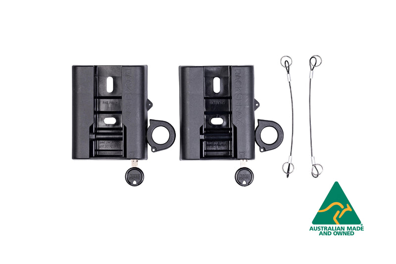 Image of two black Rack 'N' Trax awning brackets with keys and security cables, featuring an "Australian Made and Owned" logo in the bottom right corner, on a white background.