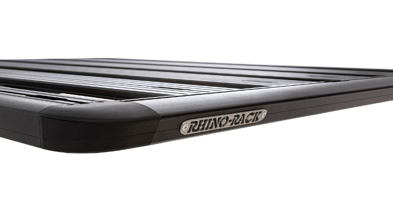 Image of Rhino-Rack roof rack, black aluminum frame with slatted design and rounded corners, close-up view with Rhino-Rack logo on white background