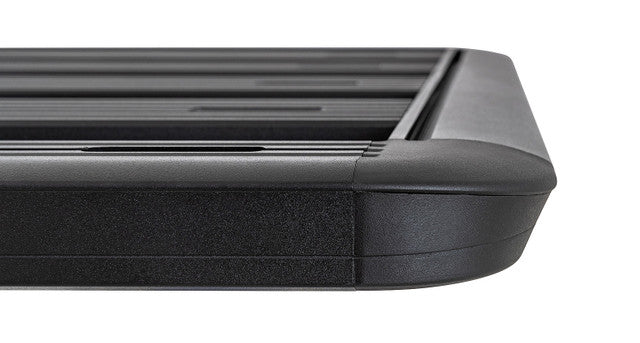 Image of Rhino-Rack roof rack, black aluminum frame with slatted design and rounded corners, close-up side view with smooth edges on white background