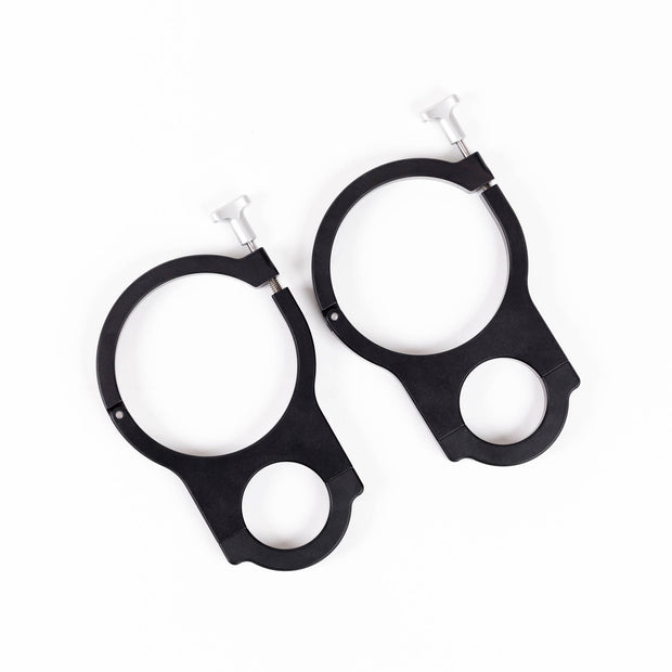 Two black RollPaX mounting rings with silver screws, lying on a white background.