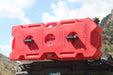 Red RotoPaX gasoline can with two black RotoPaX mounts, lying horizontally on the back of a vehicle with mountains in the background.
