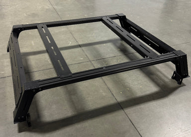 Image of Thors Lightning truck bed rack frame in black powder-coated steel, angled top and side view on concrete floor background.
