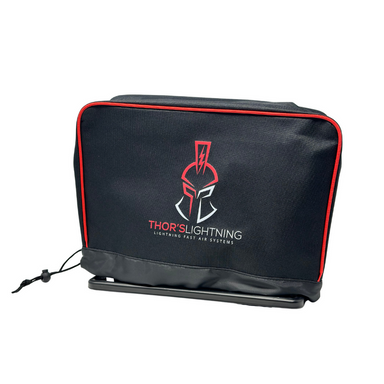 Image of Thors Lightning portable 12V air compressor protective cover in black fabric with red trim and logo, angled front view on white background.