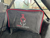Image of Thors Lightning portable 12V air compressor protective cover in black with red trim secured in vehicle cargo area, angled front view inside SUV.