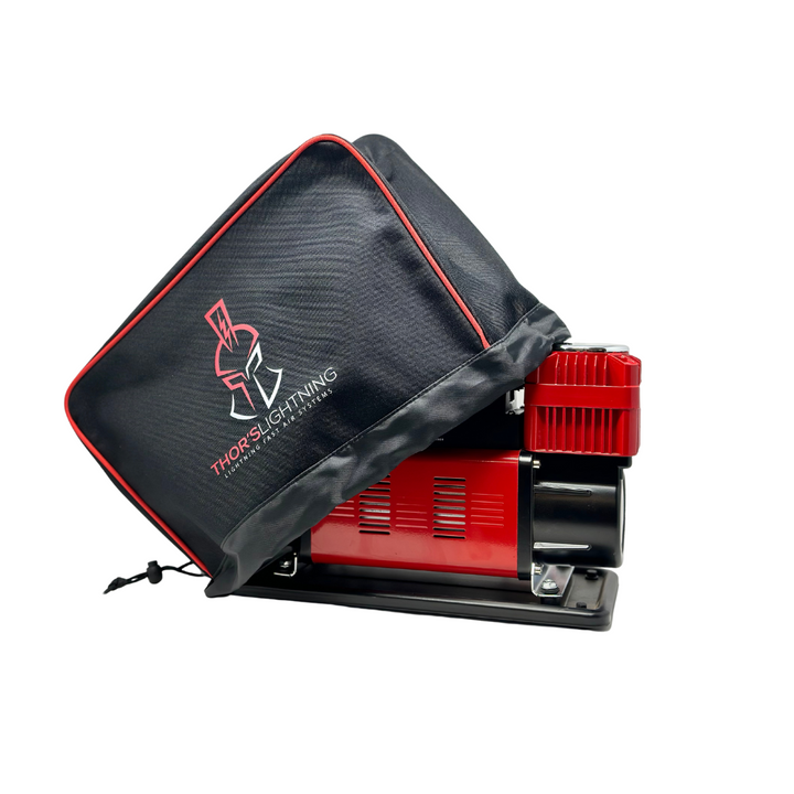 Image of Thors Lightning portable 12V air compressor partially covered with black and red protective cover, angled side view on white background.