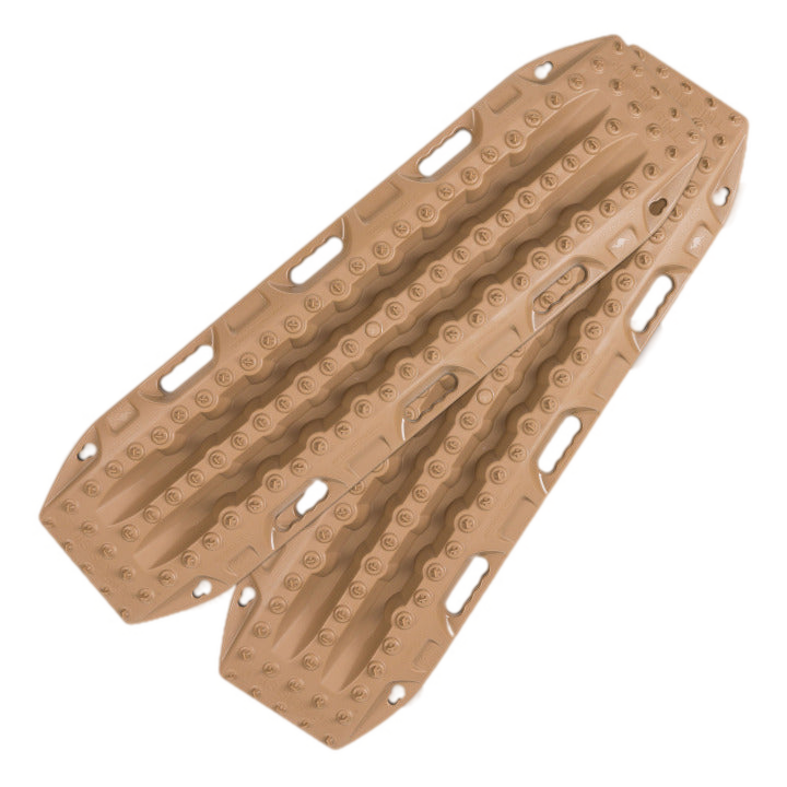 Image of two tan off-road vehicle recovery traction boards with grip patterns and handles, presented on a light grey background.