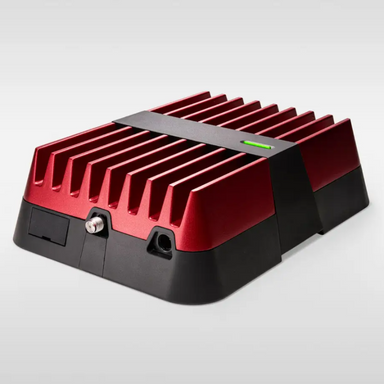 Image of a red and black electronic device with a finned top for heat dissipation, a black strap around the middle, and a single green light. The device has two ports on the front and is shown on a white background