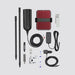 Image of a comprehensive signal booster kit, including a red and black booster unit with fins, two black pole sections, a black antenna, various cables, power adapters (wall and car), mounting hardware, and small accessory vials, all laid out on a white background