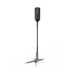 Image of a dark grey WeBoost cell signal booster unit mounted atop a tall black antenna pole, secured by a silver spring base with a ground spike, standing vertically on a black background.